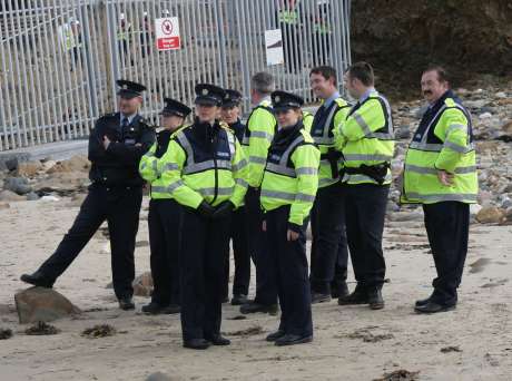 Garda look on as protesters assert their rights to access the water.