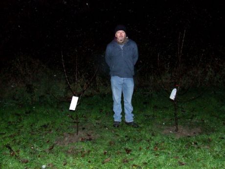 Paul between two apple trees planted in memory of dear friends