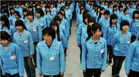 Foxconn workers line up military style before work.